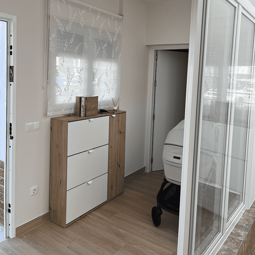 Diseño de entrada o recibidor funcional con mueble zapatero a medida en un proyecto residencial en Huelva.